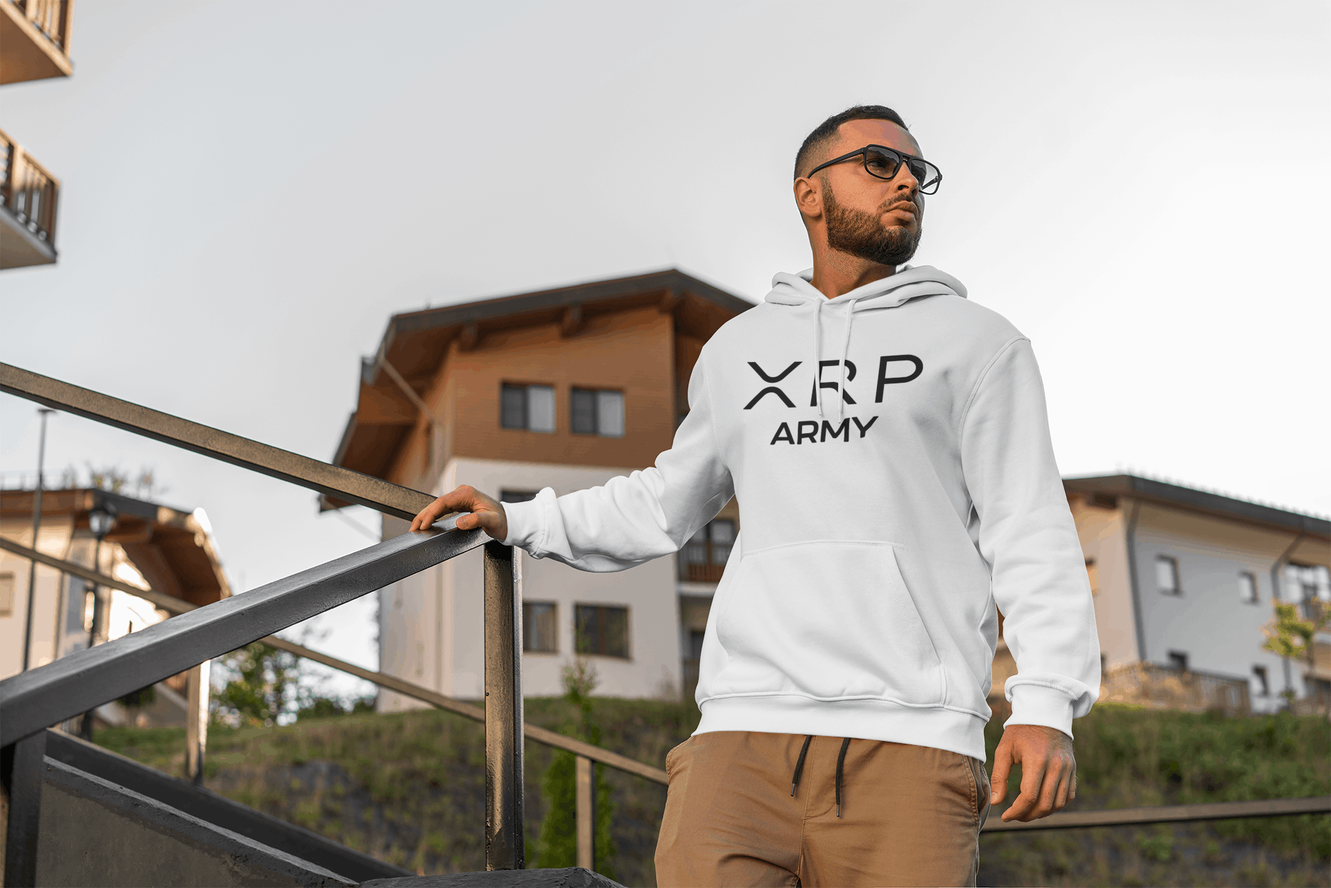 Man wearing a hoodie with 'XRP Army' text, standing outdoors.